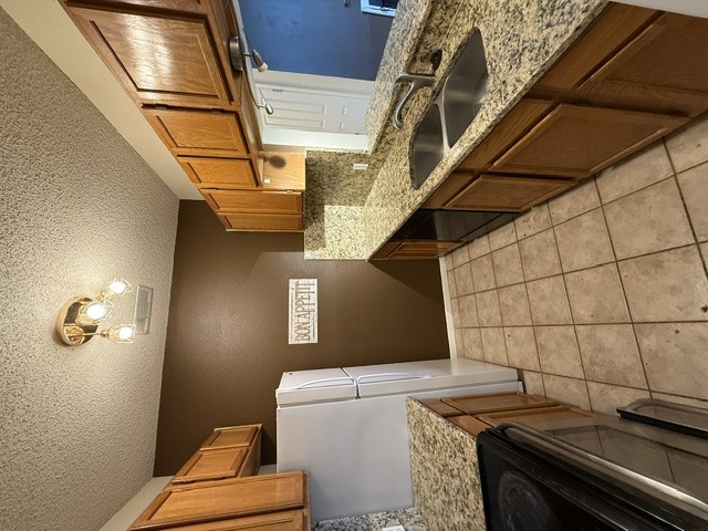 2300 Leon Street, Unit 202 Austin, TX 78705 - Photo 5 of 19 a kitchen with a sink stove and cabinets