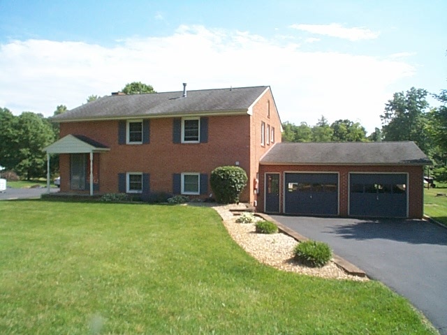 2344 Lyndhurst Road Waynesboro, VA 22980 - Photo 1 of 25 a front view of a house with a garden and yard