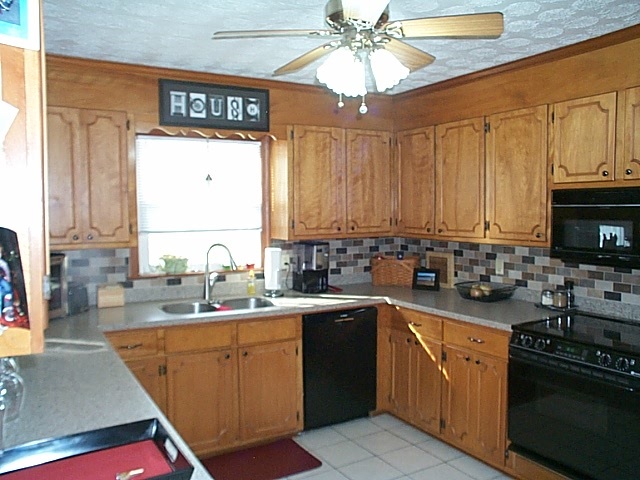 2344 Lyndhurst Road Waynesboro, VA 22980 - Photo 4 of 25 a kitchen with stainless steel appliances a sink a stove cabinets and a window