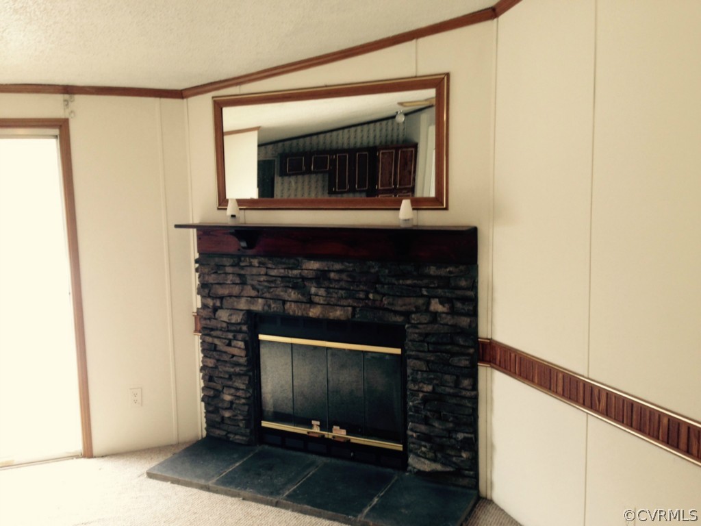 4242 Falls Road Victoria, VA 23974 - Photo 2 of 5 a living room with a fireplace and a flat screen tv