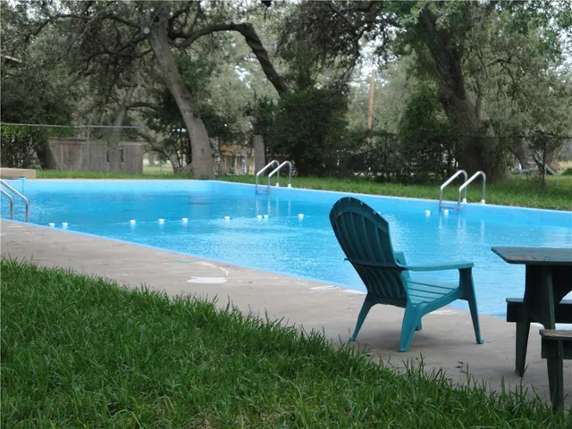 a view of yard with swimming pool and sitting area