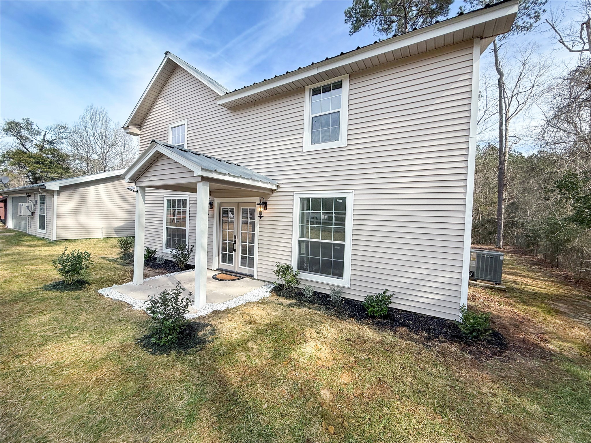 301 County Road 2734 Cleveland, TX 77327 - Photo 5 of 17 a front view of a house with a patio