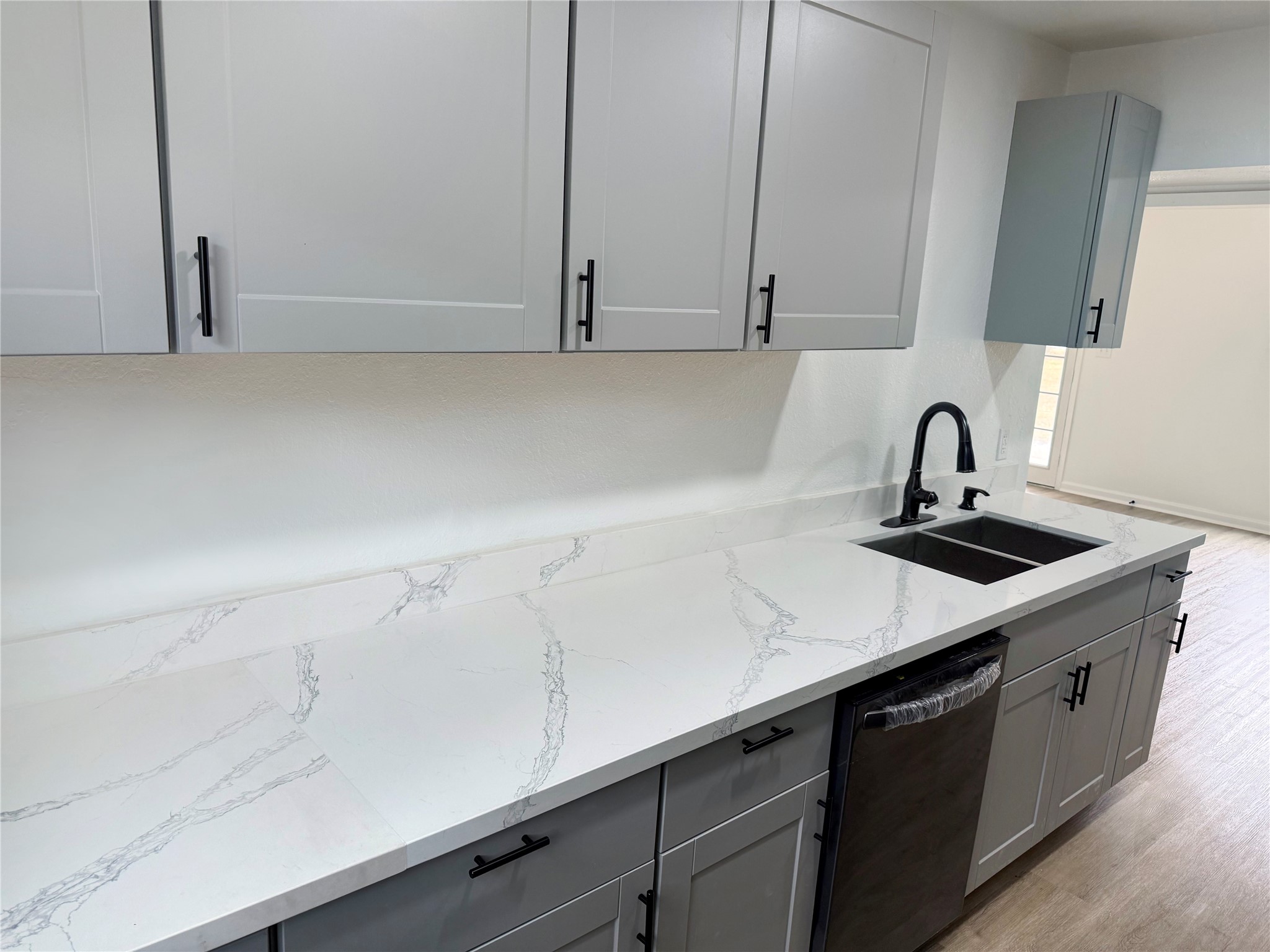 301 County Road 2734 Cleveland, TX 77327 - Photo 7 of 17 a kitchen with a sink and cabinets