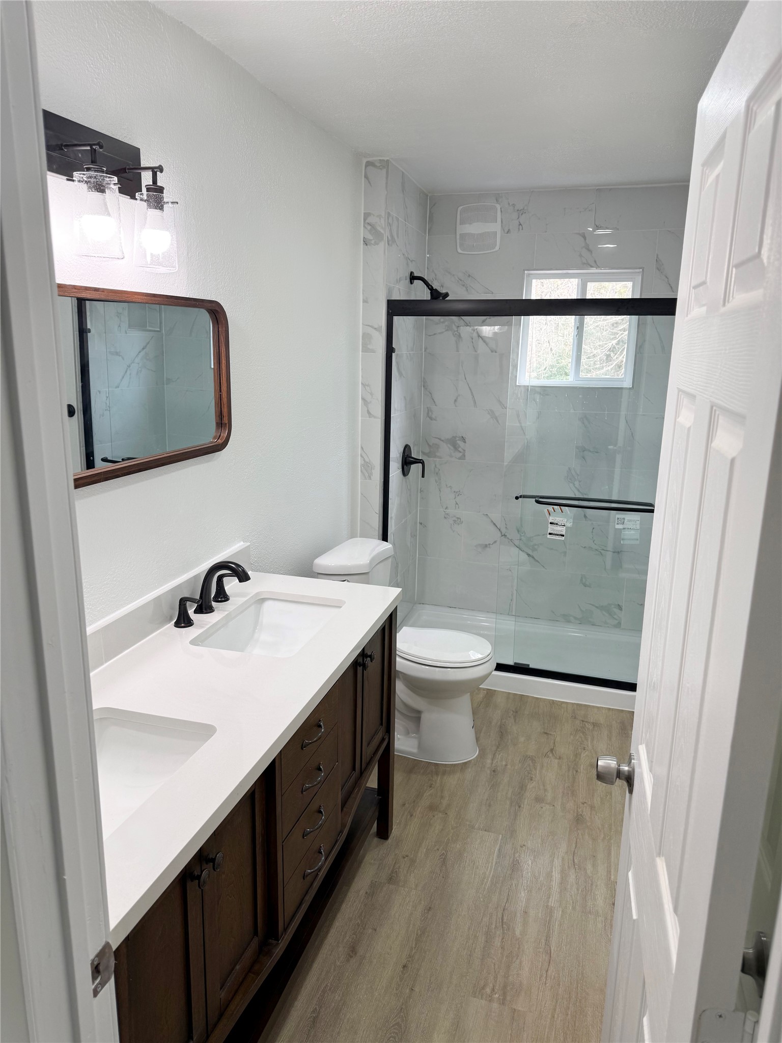 301 County Road 2734 Cleveland, TX 77327 - Photo 9 of 17 a bathroom with a sink a toilet and a mirror