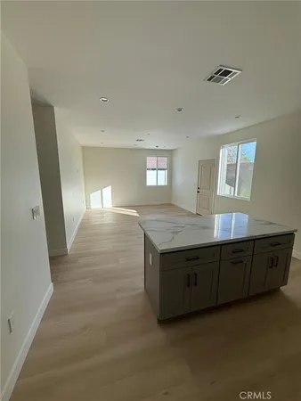 a kitchen with stainless steel appliances a sink a microwave a refrigerator and cabinets