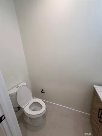 a view of a hallway with wooden floor and bathroom