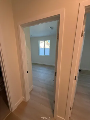 a view of walk in closet with empty racks