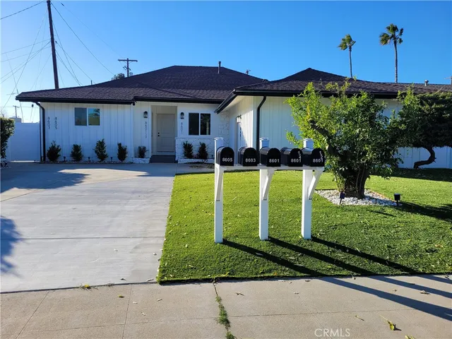 a view of a house with backyard sitting area and swimming pool