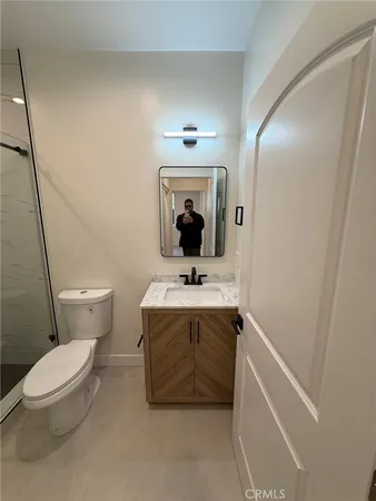 a bathroom with a toilet and a shower