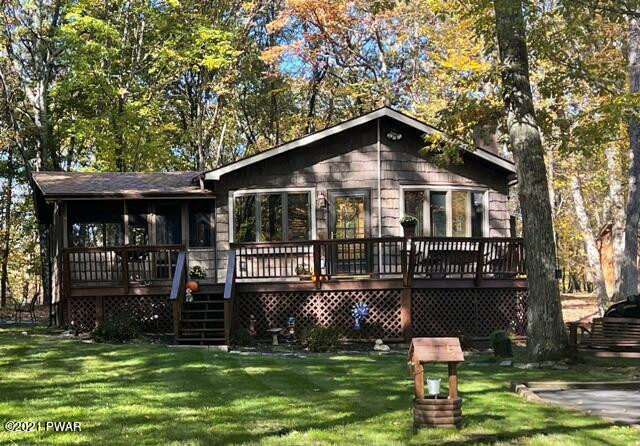 259 High Ridge Road Dingmans Ferry, PA 18328 - Photo 1 of 19 a front view of a house with a yard table and chairs