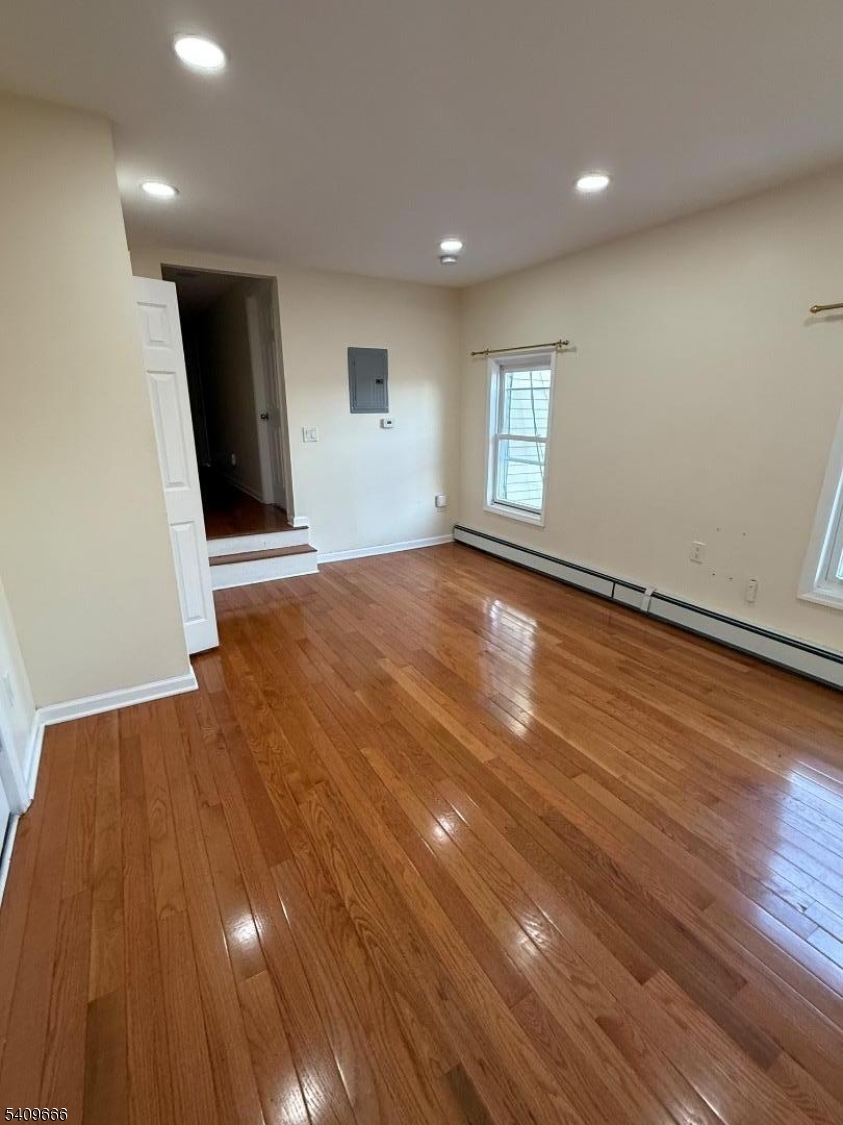 30 Elm Street, Unit 2 Newark, NJ 07102 - Photo 2 of 10 an empty room with wooden floor and windows