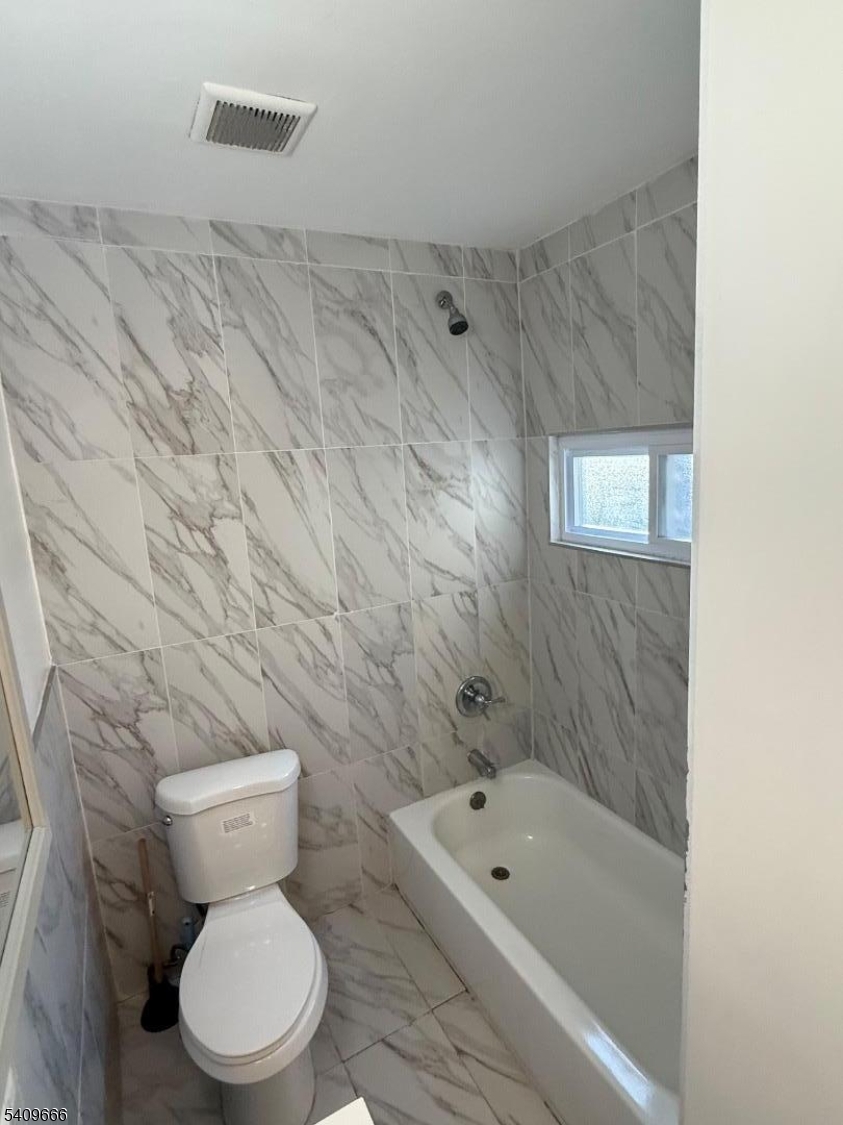 30 Elm Street, Unit 2 Newark, NJ 07102 - Photo 8 of 10 a white toilet sitting next to a bath tub and a shower