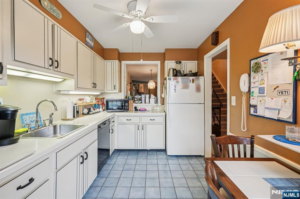 181 Long Hill Road, Unit K5 Little Falls, NJ 07424 - Photo 12 of 48 a kitchen with white cabinets and white appliances
