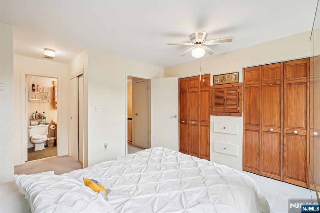 181 Long Hill Road, Unit K5 Little Falls, NJ 07424 - Photo 17 of 48 a bedroom with a bed cabinets and a walk in closet