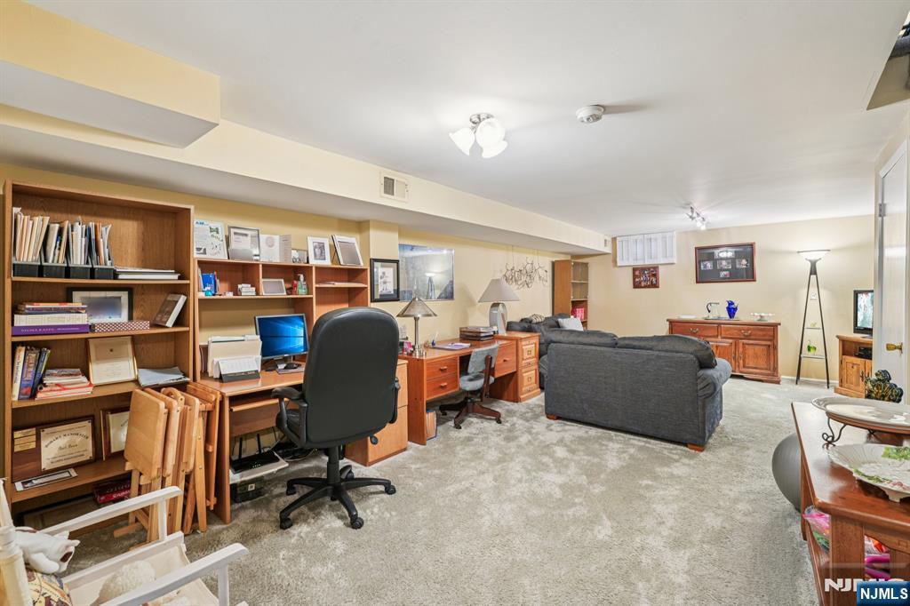 181 Long Hill Road, Unit K5 Little Falls, NJ 07424 - Photo 23 of 48 a view of a workspace with furniture and a bookshelf