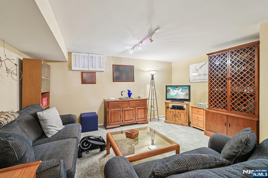 181 Long Hill Road, Unit K5 Little Falls, NJ 07424 - Photo 25 of 48 a living room with furniture and a flat screen tv