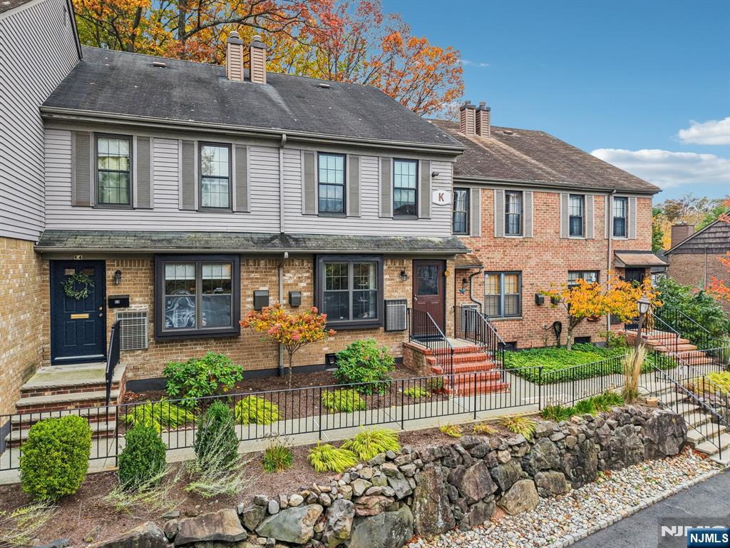 181 Long Hill Road, Unit K5 Little Falls, NJ 07424 - Photo 38 of 48 a front view of a residential apartment building with a yard