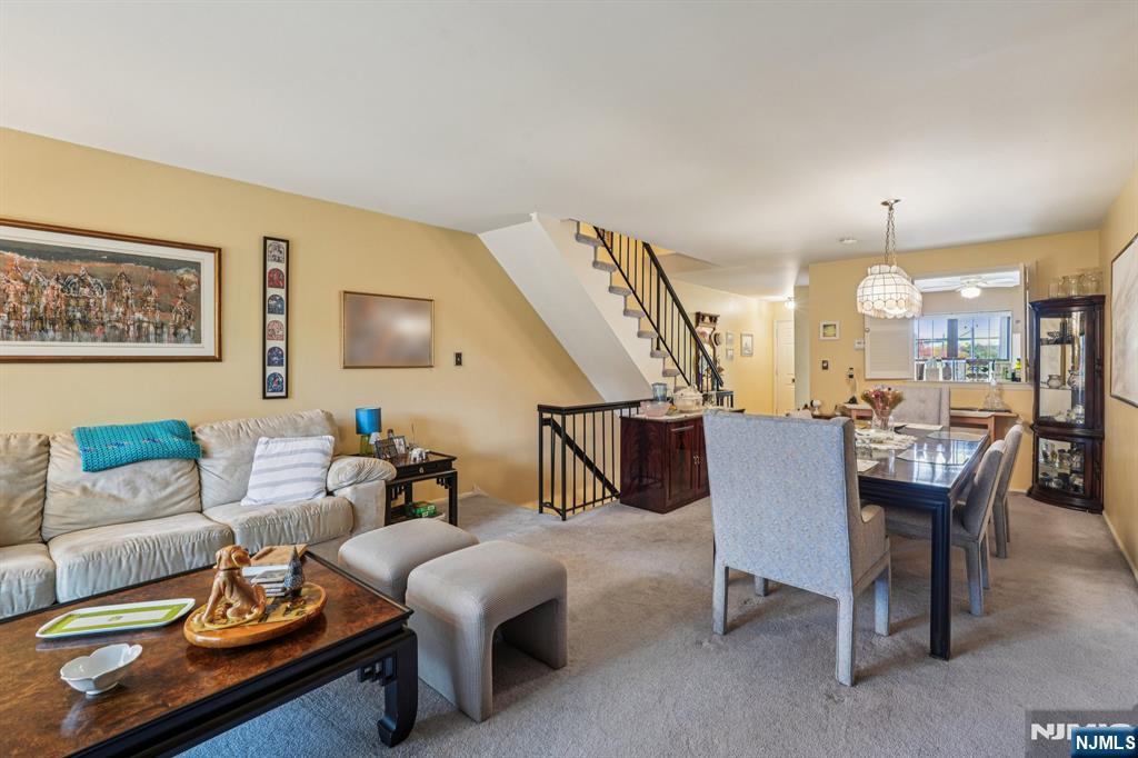 181 Long Hill Road, Unit K5 Little Falls, NJ 07424 - Photo 5 of 48 a living room with furniture kitchen view and a wooden floor