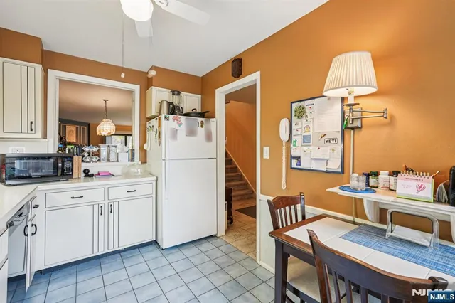 a view of a hallway with workspace and a window