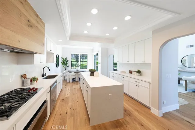 a kitchen with stove a sink and a refrigerator