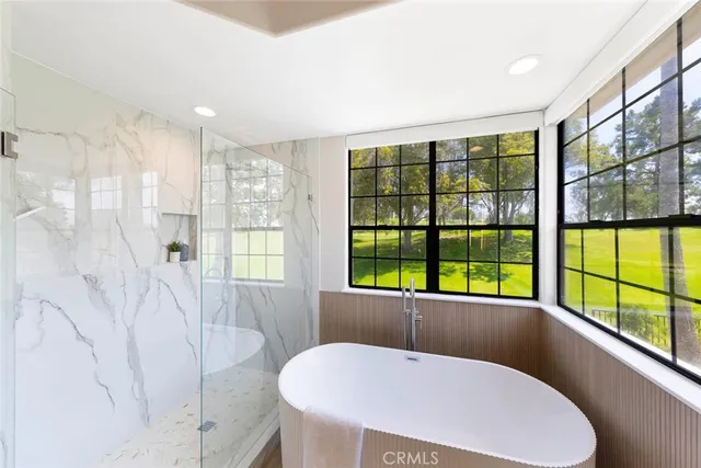 a bathroom with a tub and a window