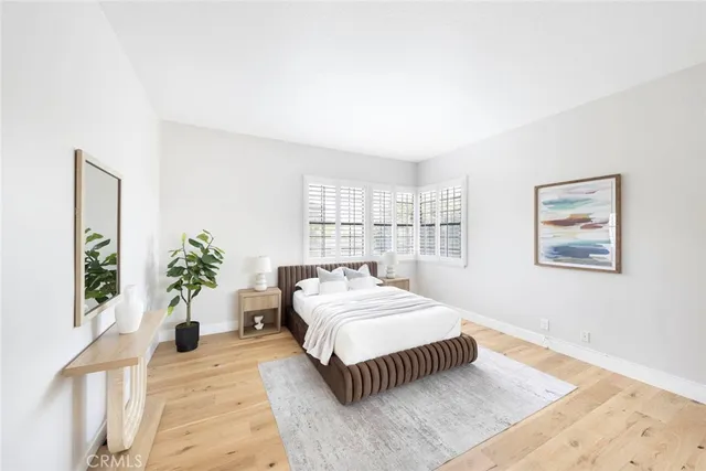 a bedroom with a large bed and a large window