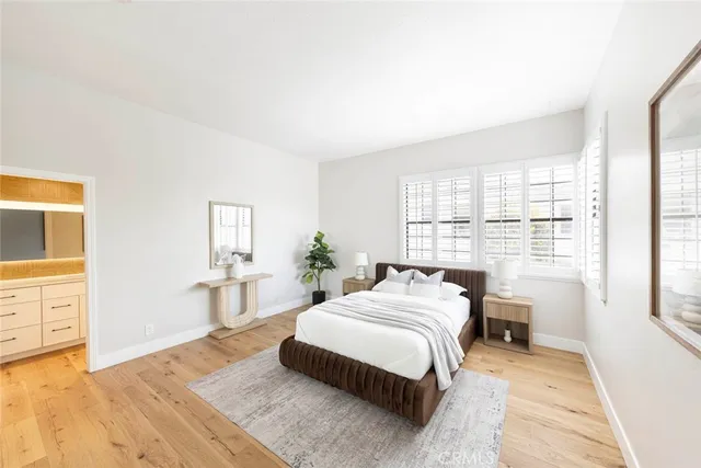 a spacious bedroom with a bed a dresser and next to a window