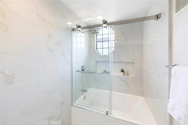 a bathroom with a bathtub and a shower