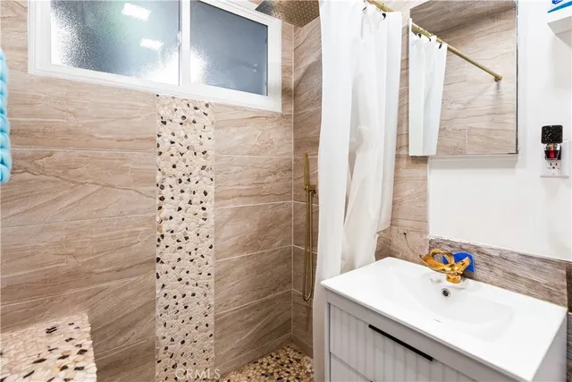 a bathroom with a sink a mirror and shower