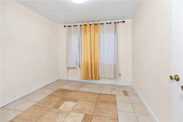 a view of a room with window and brick walls