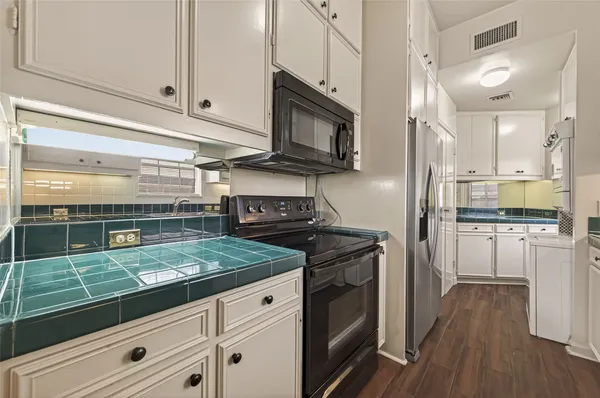 a view of a kitchen with a sink and a refrigerator cabinets
