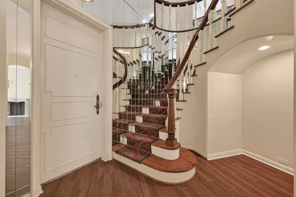 a view of empty room with wooden floor and fireplace