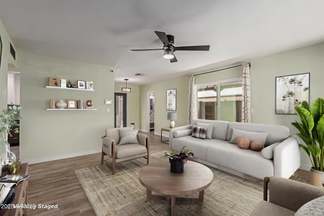 a living room with furniture and a wooden floor