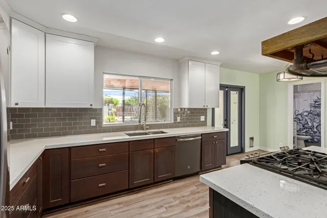 a kitchen with a sink stove and cabinets