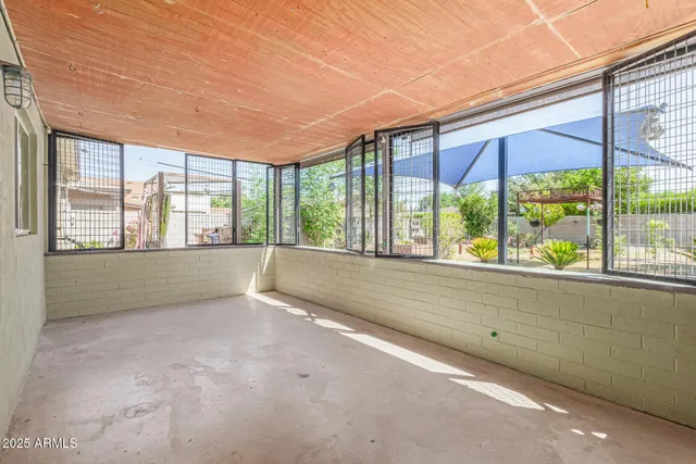 an empty room with large windows