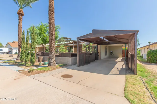 a view of a patio with a table and chairs under an umbrella