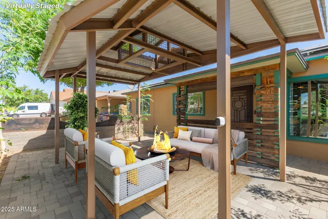 a view of a patio with a table and chairs and potted plants