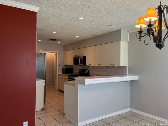 a kitchen with stainless steel appliances a sink and a refrigerator