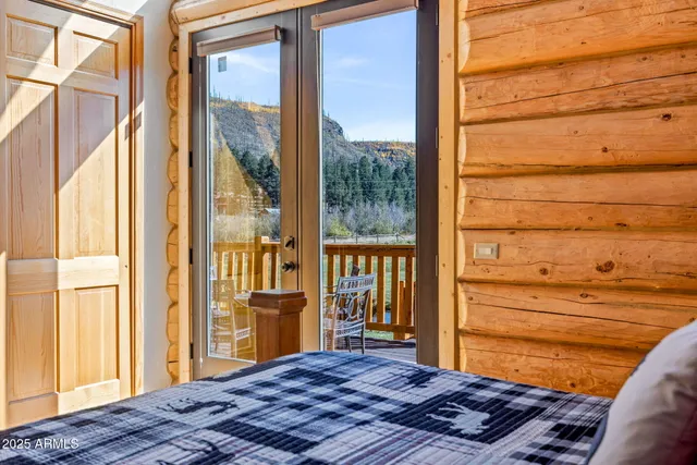 a bedroom with a bed and a chandelier