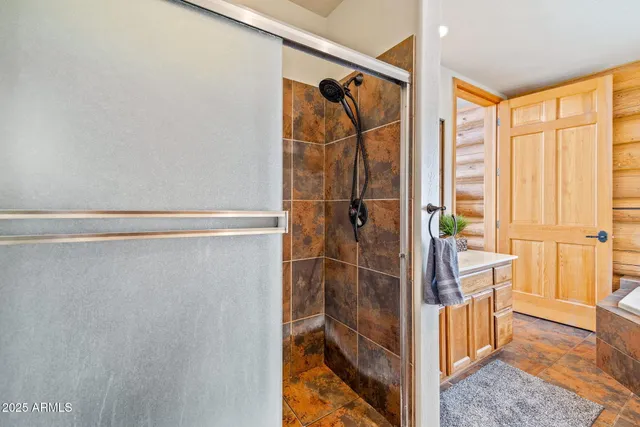 a bedroom with a bed a stove and a dresser with the outer view