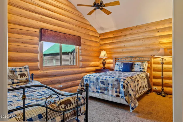 a bedroom with a bed a dresser and a window