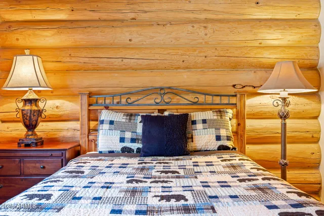 a bedroom with a bed and a dresser next to a window