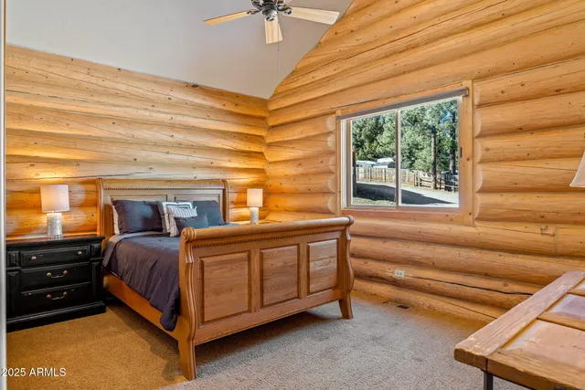 a bed room with a bed and next to a window