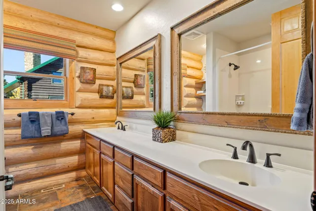 a bathroom with a tub a sink and a window