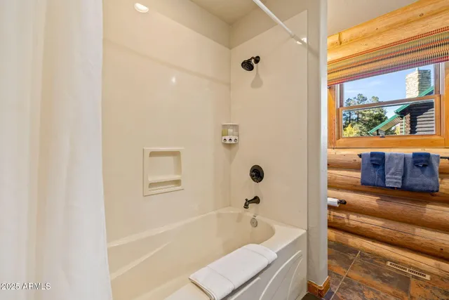 a view of a balcony with wooden floor and iron stairs