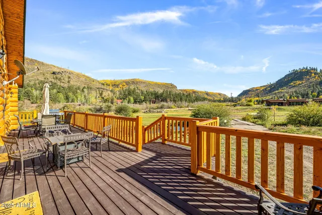 a view of a balcony with wooden floor and city view