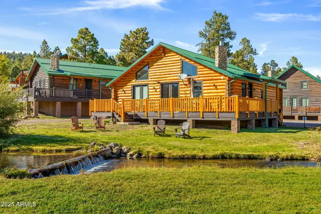 an aerial view of a house with swimming pool garden and outdoor seating
