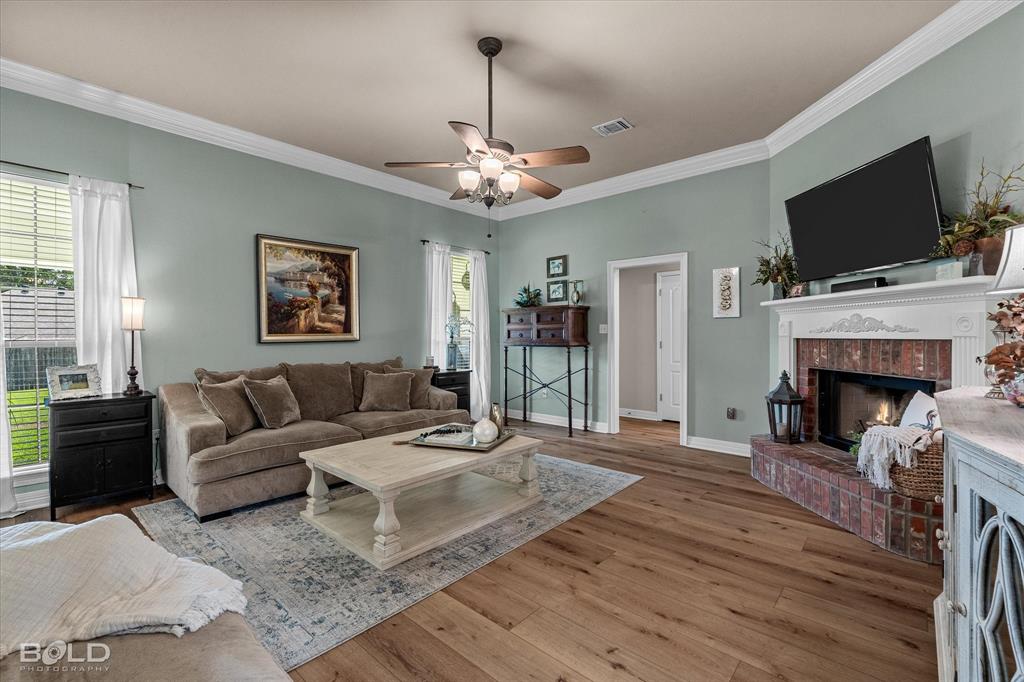 116 Augusta Avenue Benton, LA 71006 - Photo 8 of 38 a living room with furniture fireplace and flat screen tv