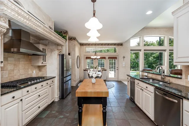 a kitchen with granite countertop a sink and a stove