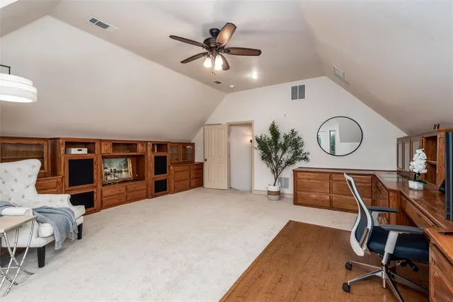 a view of a livingroom with furniture and a ceiling fan